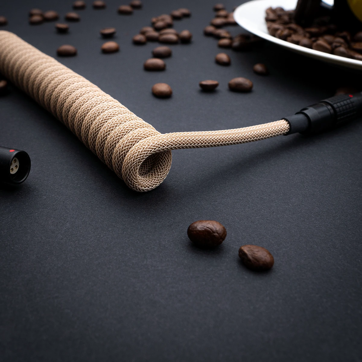 Custom GMK Café keyboard cable featuring a coiled paracord design, robust connectors, and sleek finish for enhanced durability and style.