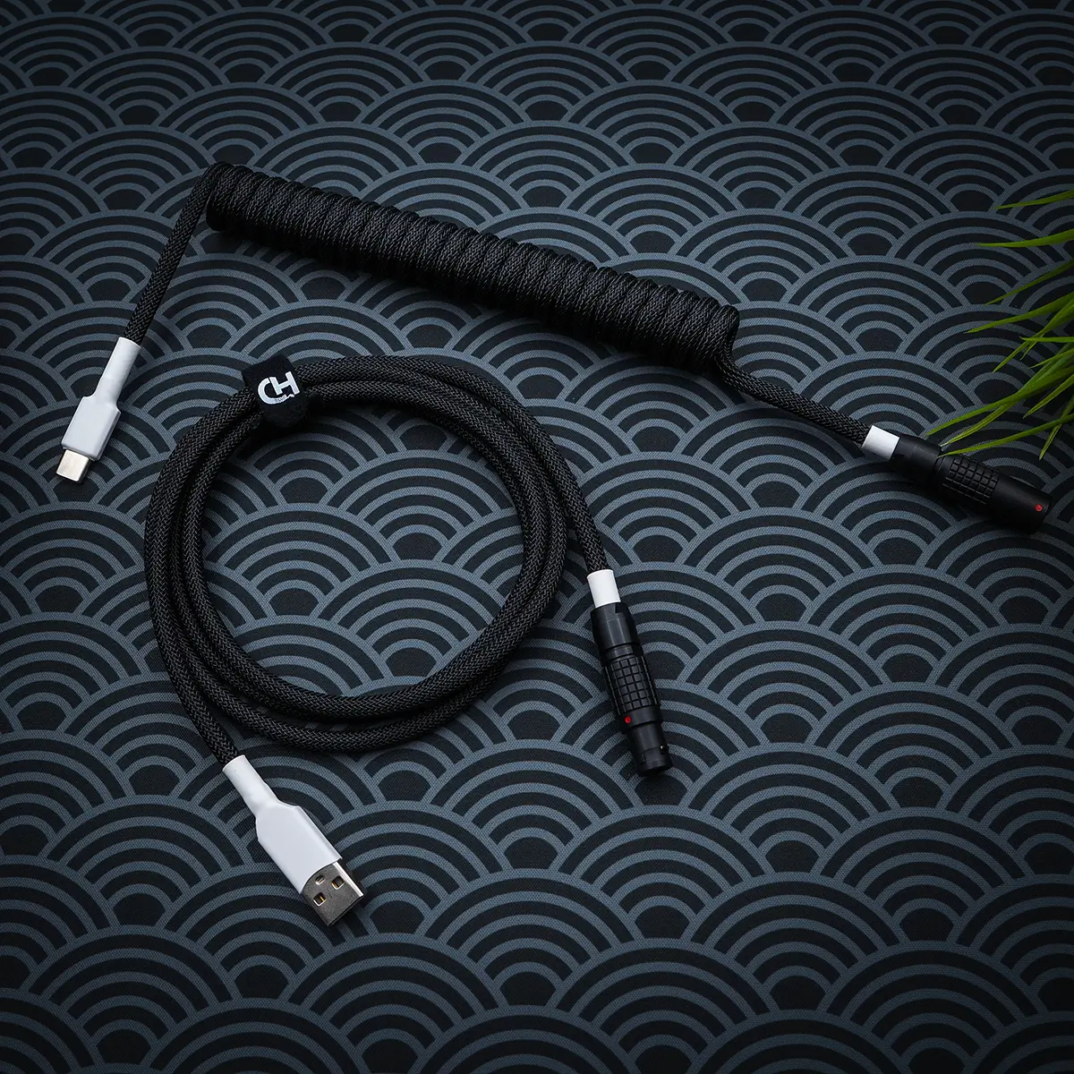 Stylish GMK Wob keyboard cable featuring a black paracord braid, coil section, USB-C and aviator connectors, ensuring durability and a sleek finish.