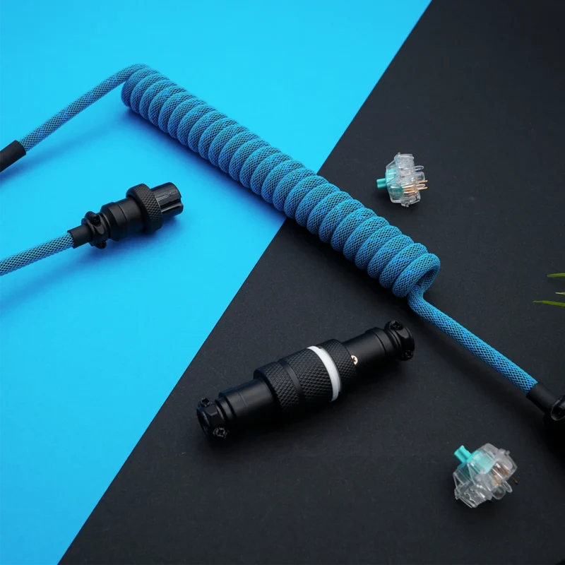Custom keyboard cable with a vibrant blue coiled paracord, featuring detachable aviator and GX16 connectors, showcasing high-quality braiding and finish.