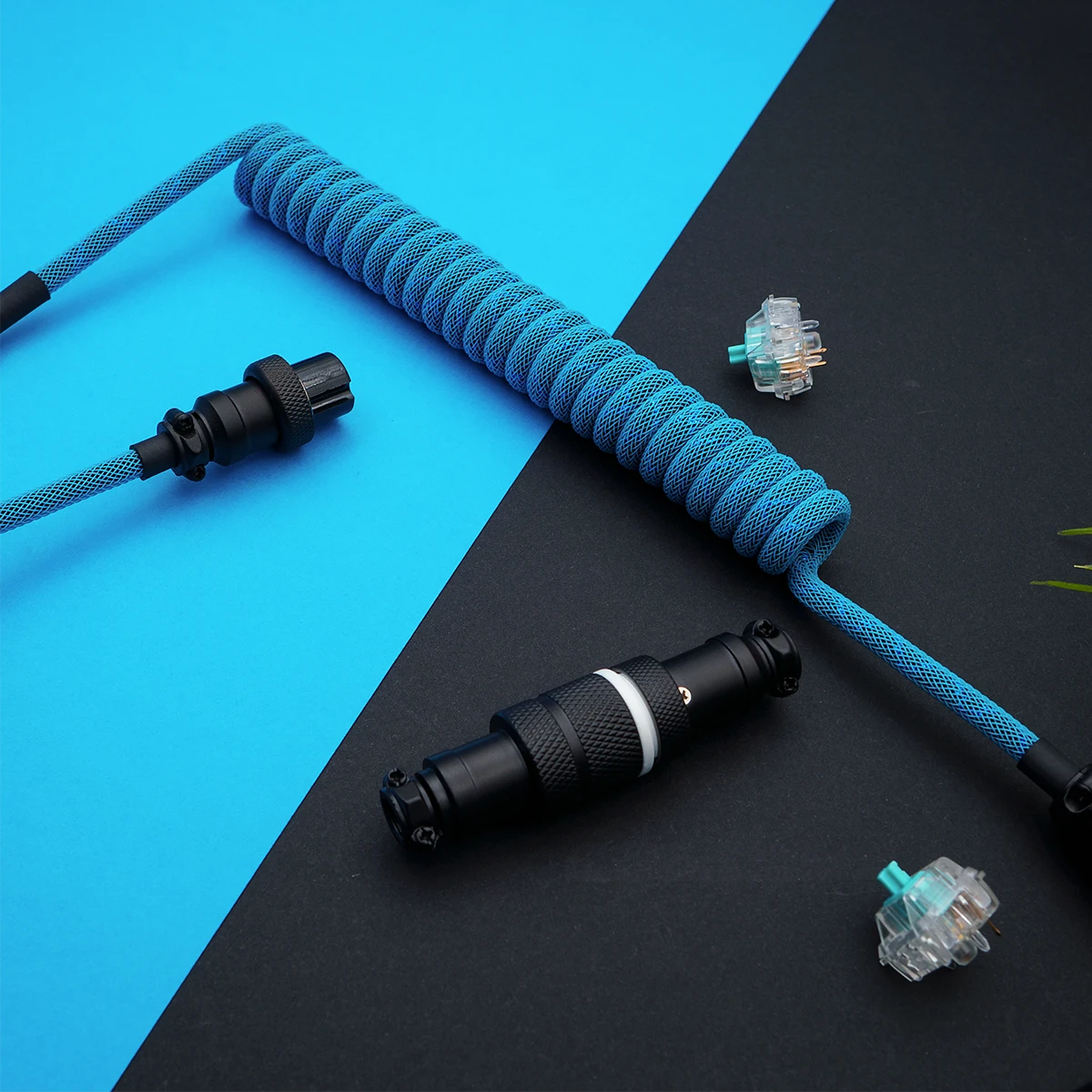 Custom keyboard cable with a vibrant blue coiled paracord, featuring detachable aviator and GX16 connectors, showcasing high-quality braiding and finish.