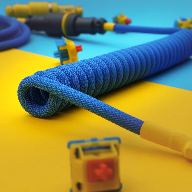Coiled blue paracord keyboard cable with detachable USB-C and micro-USB connectors, showcasing excellent braiding and heatshrink finishes.