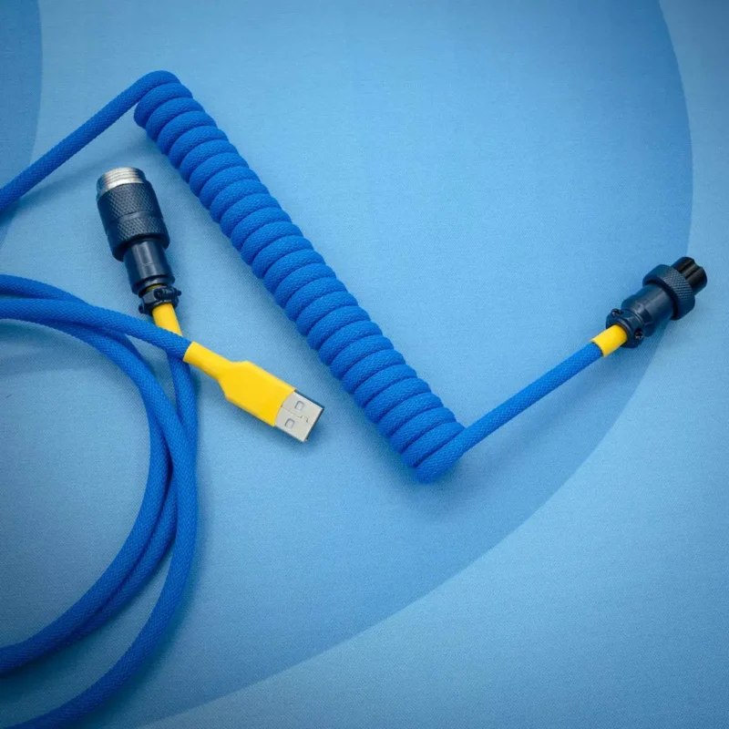Coiled blue keyboard cable with yellow accents, featuring USB connectors, CNC metal housing, and sleek paracord texture for durability and style.