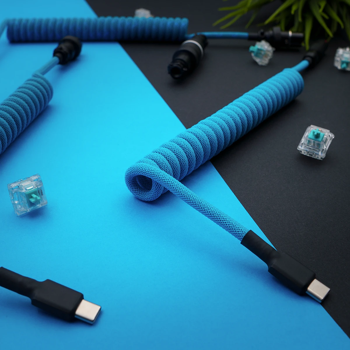 Custom keyboard cable featuring a vibrant blue paracord wrap, coiled section, straight USB-C end, and high-quality connectors, enhancing your setup’s aesthetic.