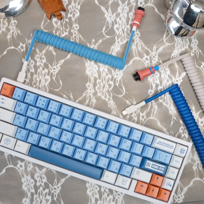 Custom keyboard cables showcase a blue coiled design with detachable connectors, including USB-C and aviator. Features include premium braiding and quality heatshrink.