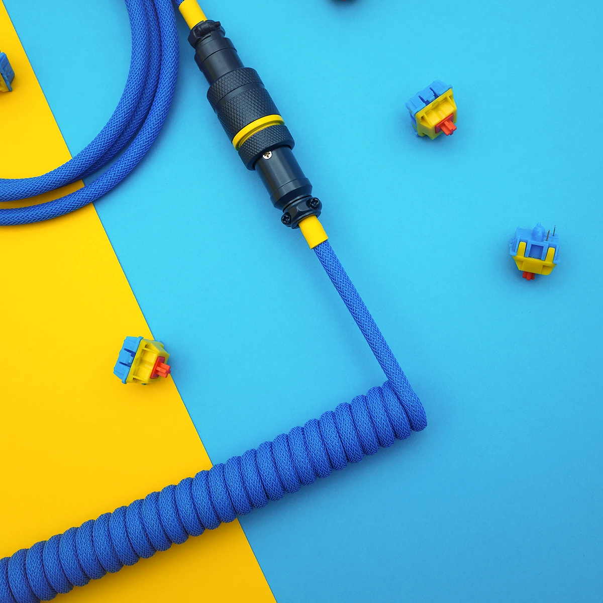 Coiled blue keyboard cable featuring a detachable aviator connector, durable paracord, and clean braiding. Ideal for custom setups.