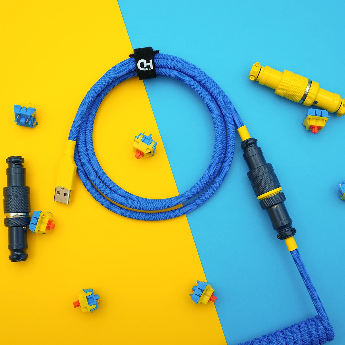 Custom blue keyboard cable featuring a coiled design, USB-A connector, and robust detachable plugs in CNC metal housing for durability.