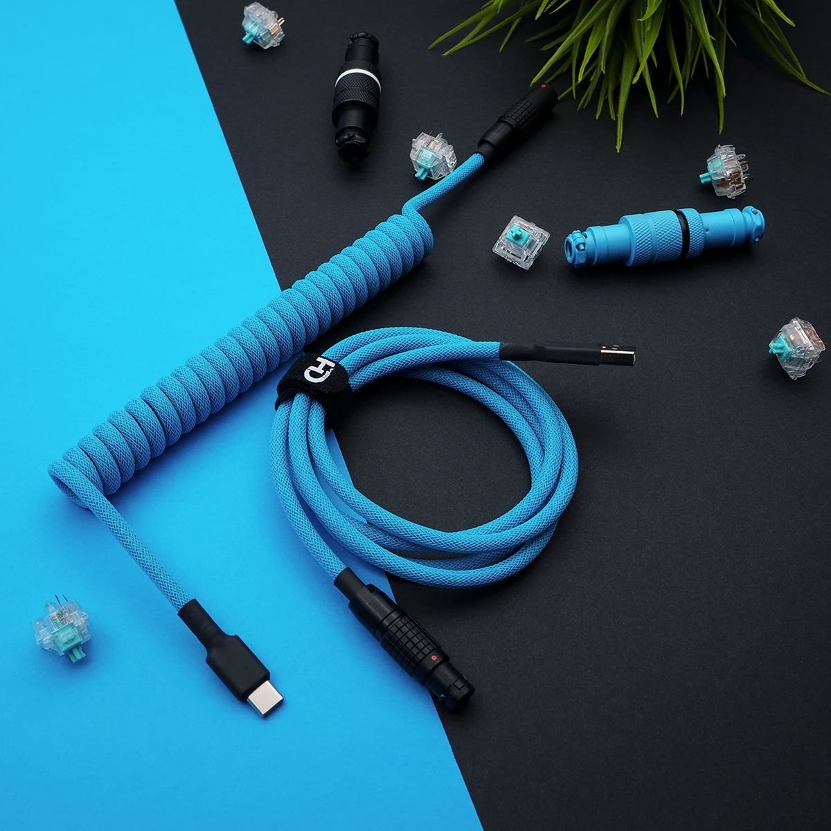 Custom blue GMK Pulse keyboard cable featuring a coiled design, USB-C and aviator connectors, high-quality paracord, and sleek braiding for durability.