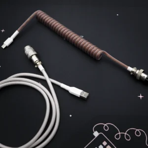 Custom brown Eevee keyboard cable featuring a coiled design, USB-C and aviator connectors, complementing gray straight section, premium braid finish.