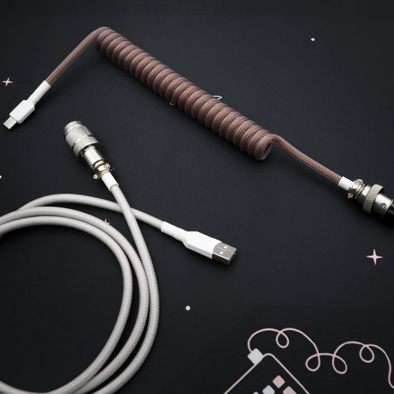 Custom brown Eevee keyboard cable featuring a coiled design, USB-C and aviator connectors, complementing gray straight section, premium braid finish.