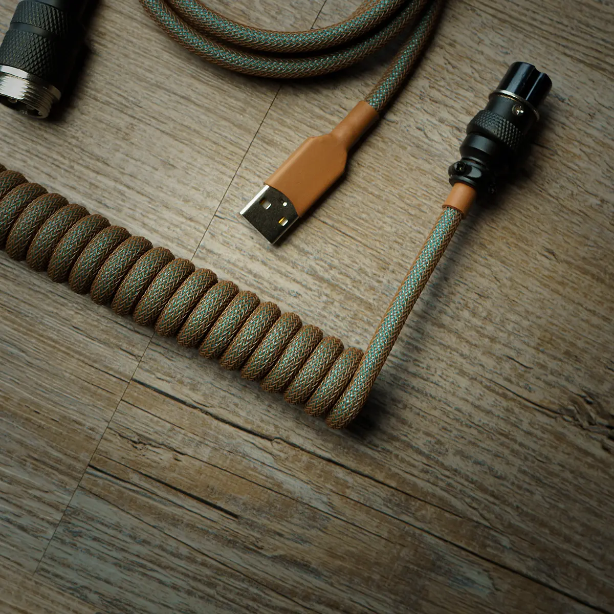 Custom GMK Copper Keyboard Cable featuring a coiled design, USB connector, and braided paracord in earthy tones for enhanced durability and style.