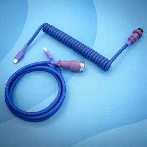 Coiled dark purple keyboard cable with detachable USB-C and aviator connectors. Features durable paracord braiding and high-quality CNC metal housing.