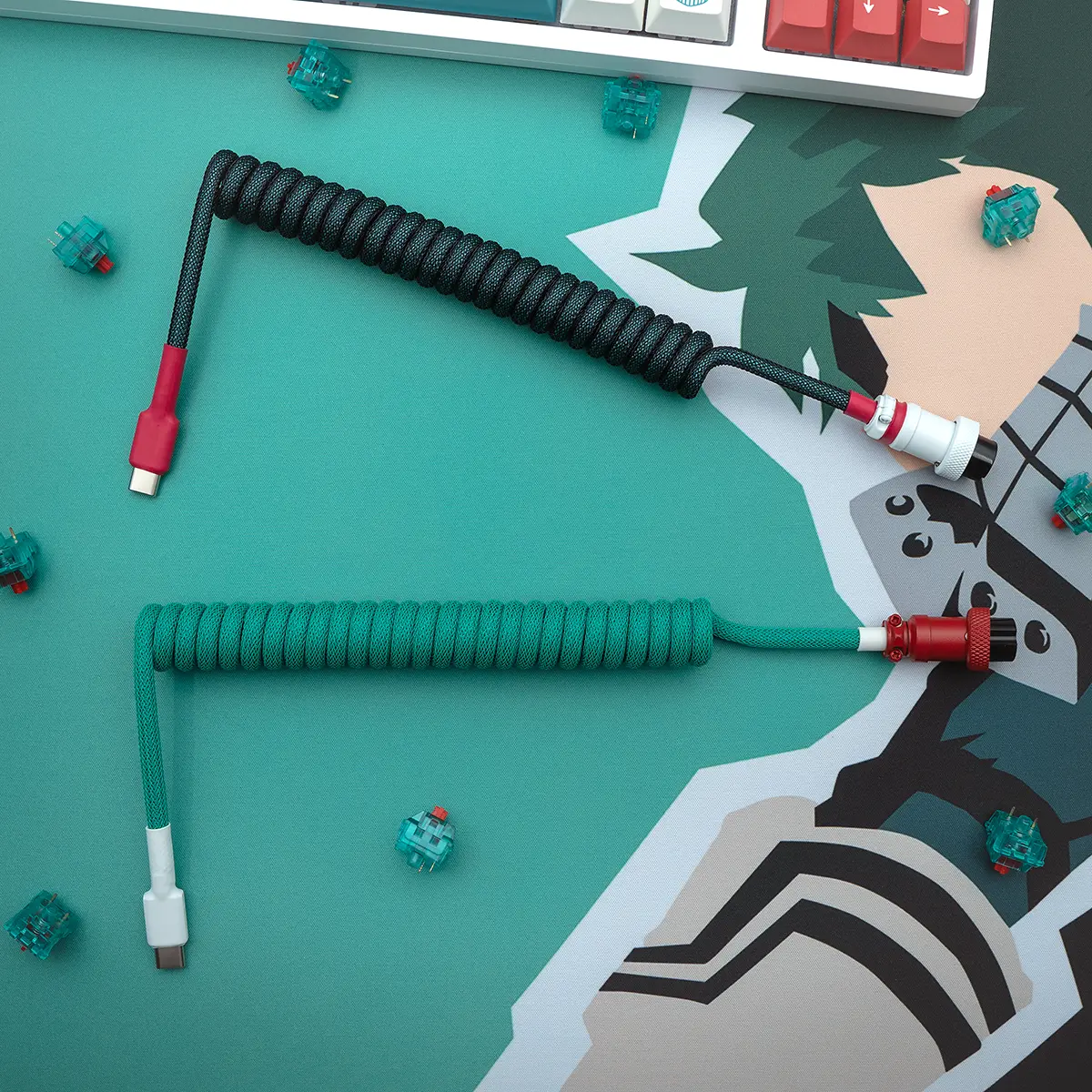 Coiled keyboard cables in black and green paracord, featuring USB-C connectors and detachable plugs. High-quality finish with braided textures.