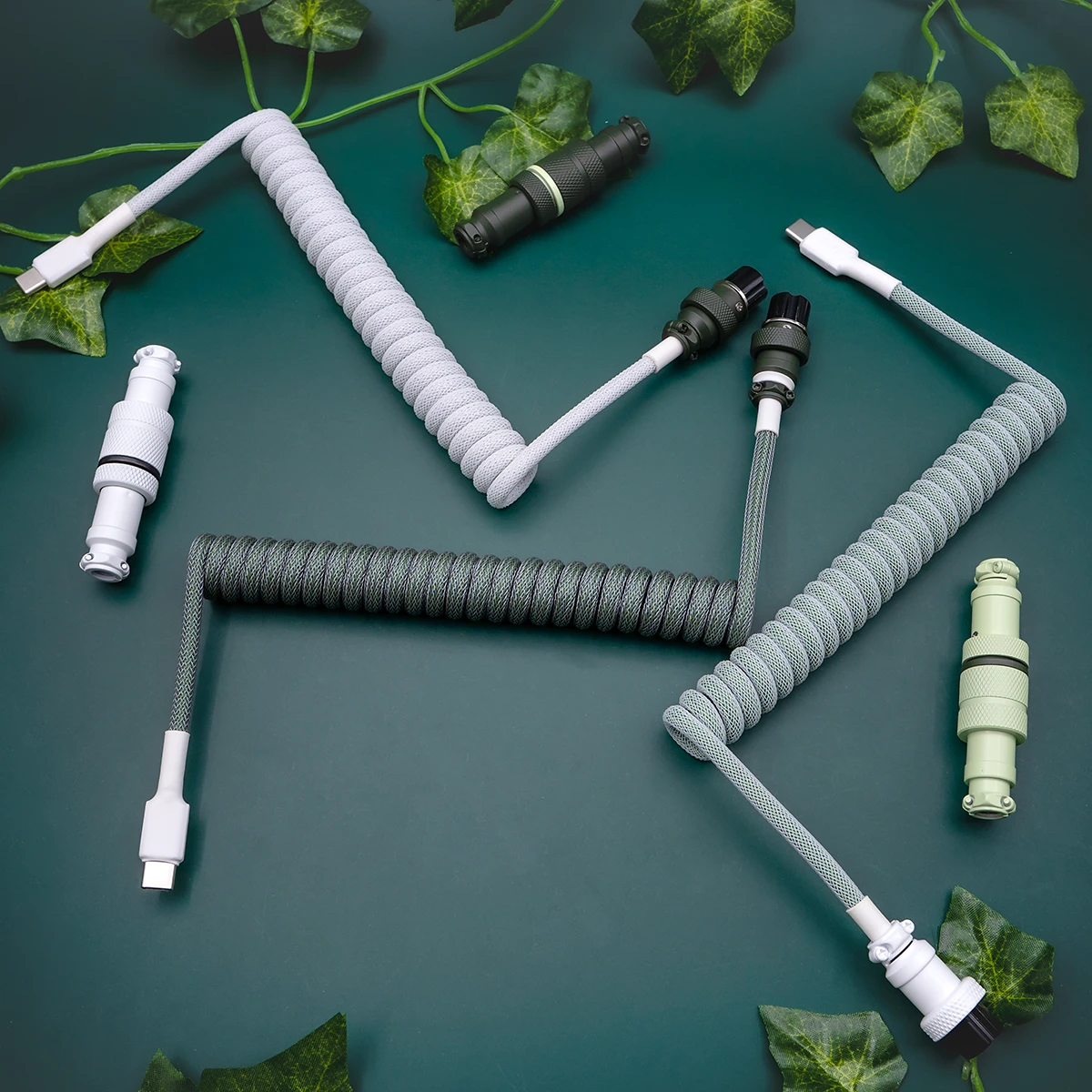 Coiled custom keyboard cables featuring USB-C and aviator connectors, with a sleek green and gray paracord finish for durability and style.