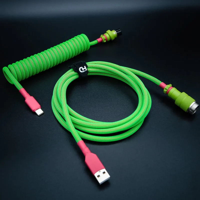 Bright green Joker Keyboard Cable with a coil section and straight part. Features USB-C and aviator connectors, durable paracord, and high-quality braiding.