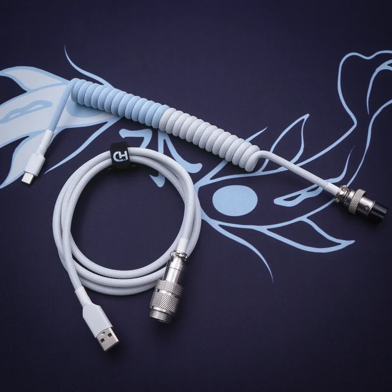 Custom keyboard cable featuring a coiled design in a soft blue and gray color scheme. Includes USB-C and aviator connectors with durable braiding and quality finish.