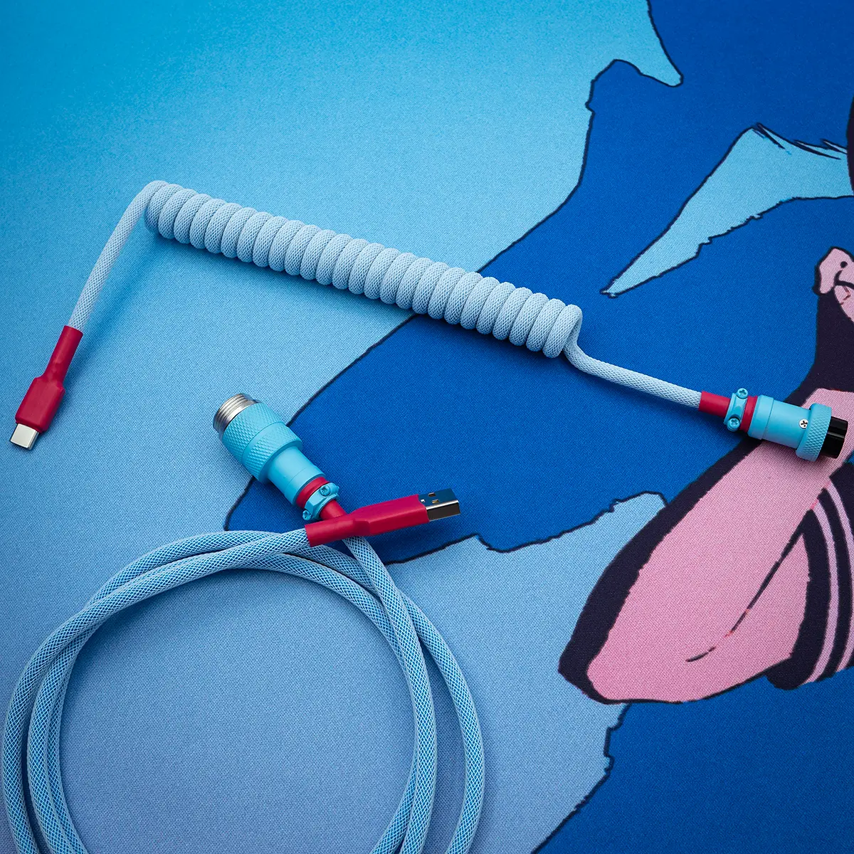 Custom GMK Oni keyboard cable featuring a coiled design with a straight section, USB-C and aviator connectors, and a vibrant blue paracord finish.