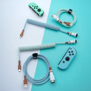 Coiled PBT Islander keyboard cable featuring USB-C and aviator connectors, finished in a stylish mint color scheme with textured paracord and quality braiding.
