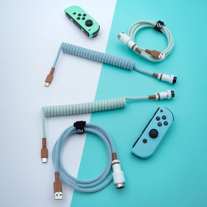 Coiled PBT Islander keyboard cable featuring USB-C and aviator connectors, finished in a stylish mint color scheme with textured paracord and quality braiding.