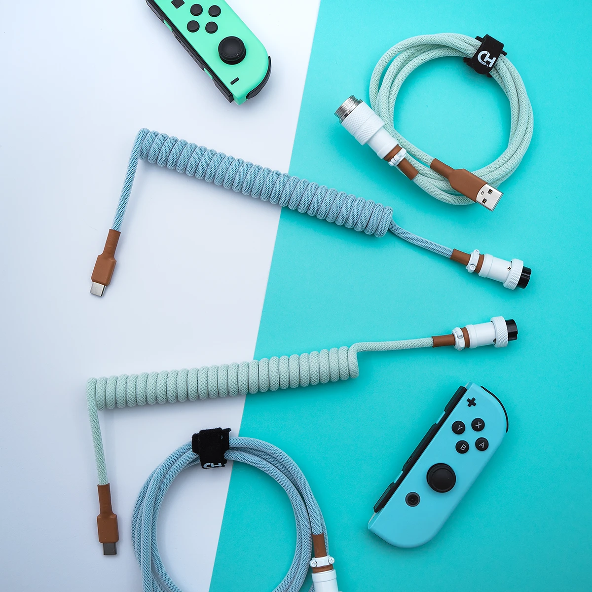 Curled light blue PBT Islander keyboard cable features USB-C and aviatior connectors, sleek paracord design, and quality heatshrink for durability.