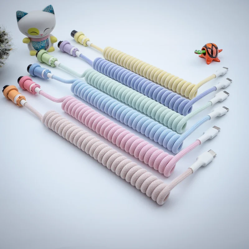 Colorful PBT milkshake keyboard cables with coiled design and smooth straight sections. Features USB-C connectors in various pastel colors with detachable plugs.