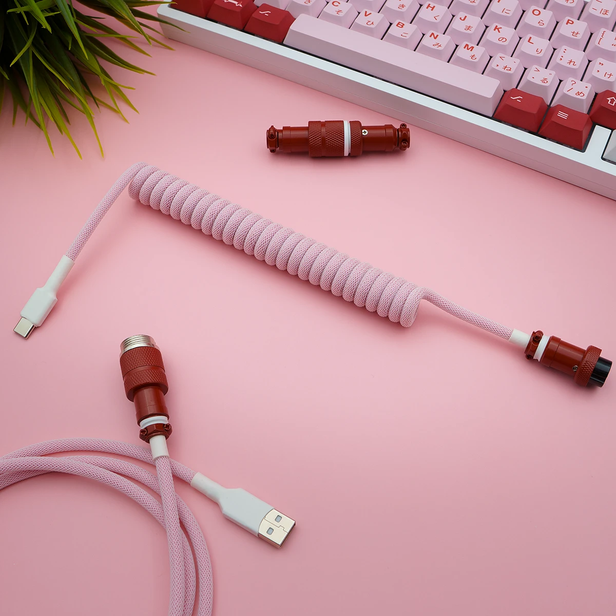 Custom GMK Darling keyboard cable featuring a pink coiled paracord design, USB-C connector, and detachable aviator plug for versatile use.
