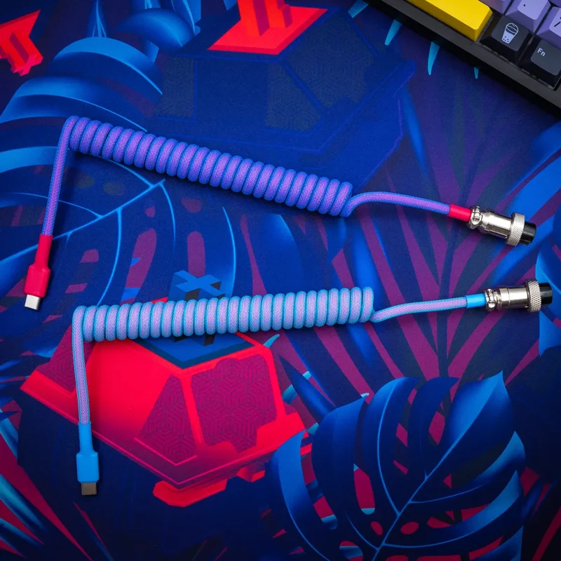 Coiled GMK Vaporwave keyboard cable featuring vibrant braided paracord, USB-C and aviator connectors, with smooth finish and high-quality heatshrink.