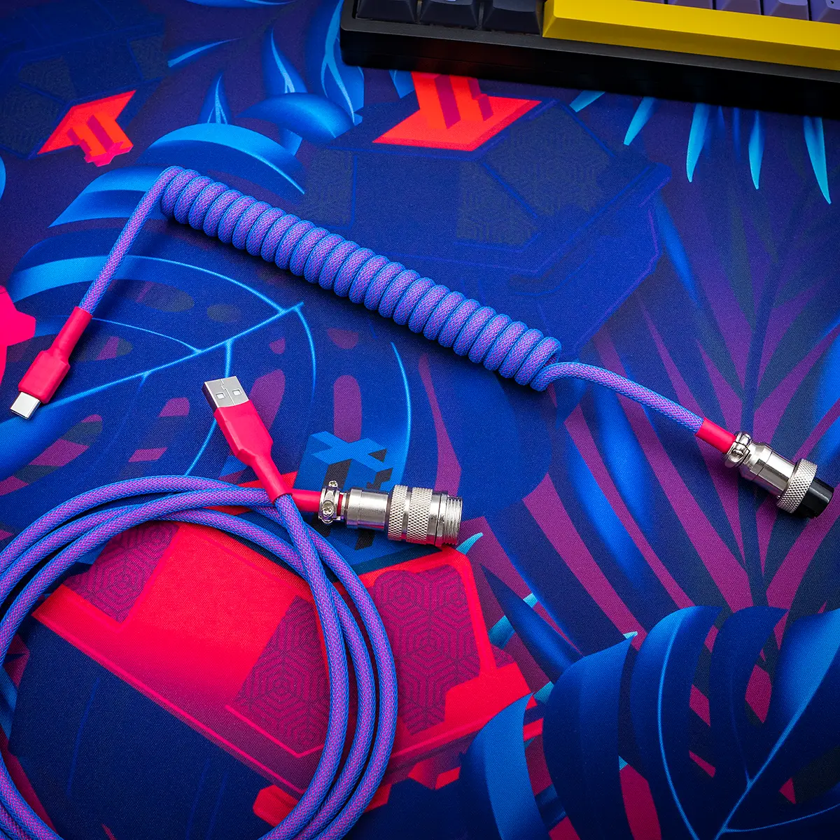 Coiled purple paracord keyboard cable featuring USB-C and aviator connectors, crafted with quality CNC metal housing for durability and style.