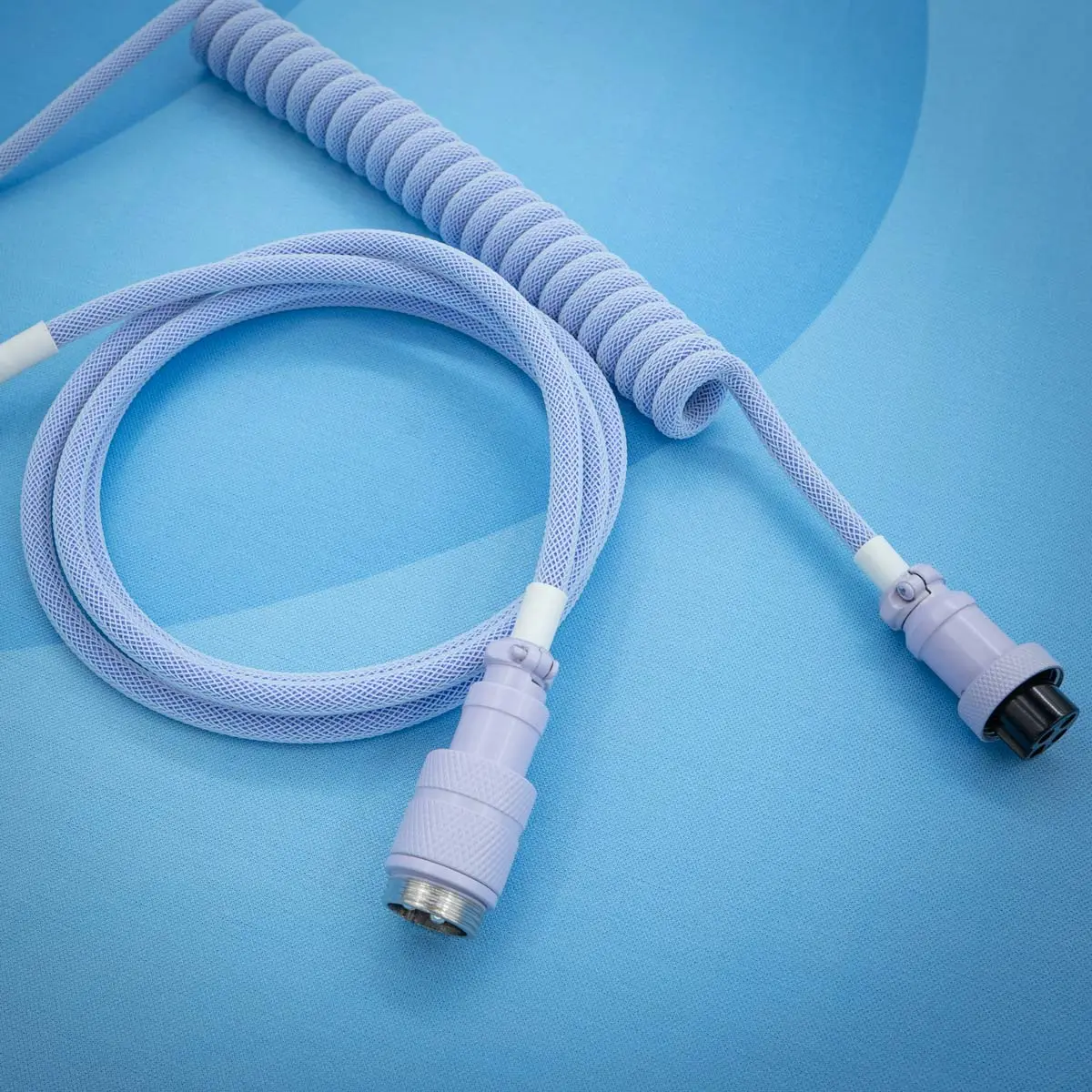 A vibrant purple keyboard cable featuring a coiled design and smooth paracord finish. Includes detachable connectors: USB-C and purple aviator gx16 types for versatile use.