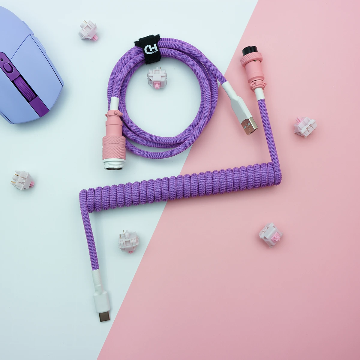 Purple coiled keyboard cable featuring USB-C and aviator connectors, wrapped in a textured paracord finish, ideal for custom setups.