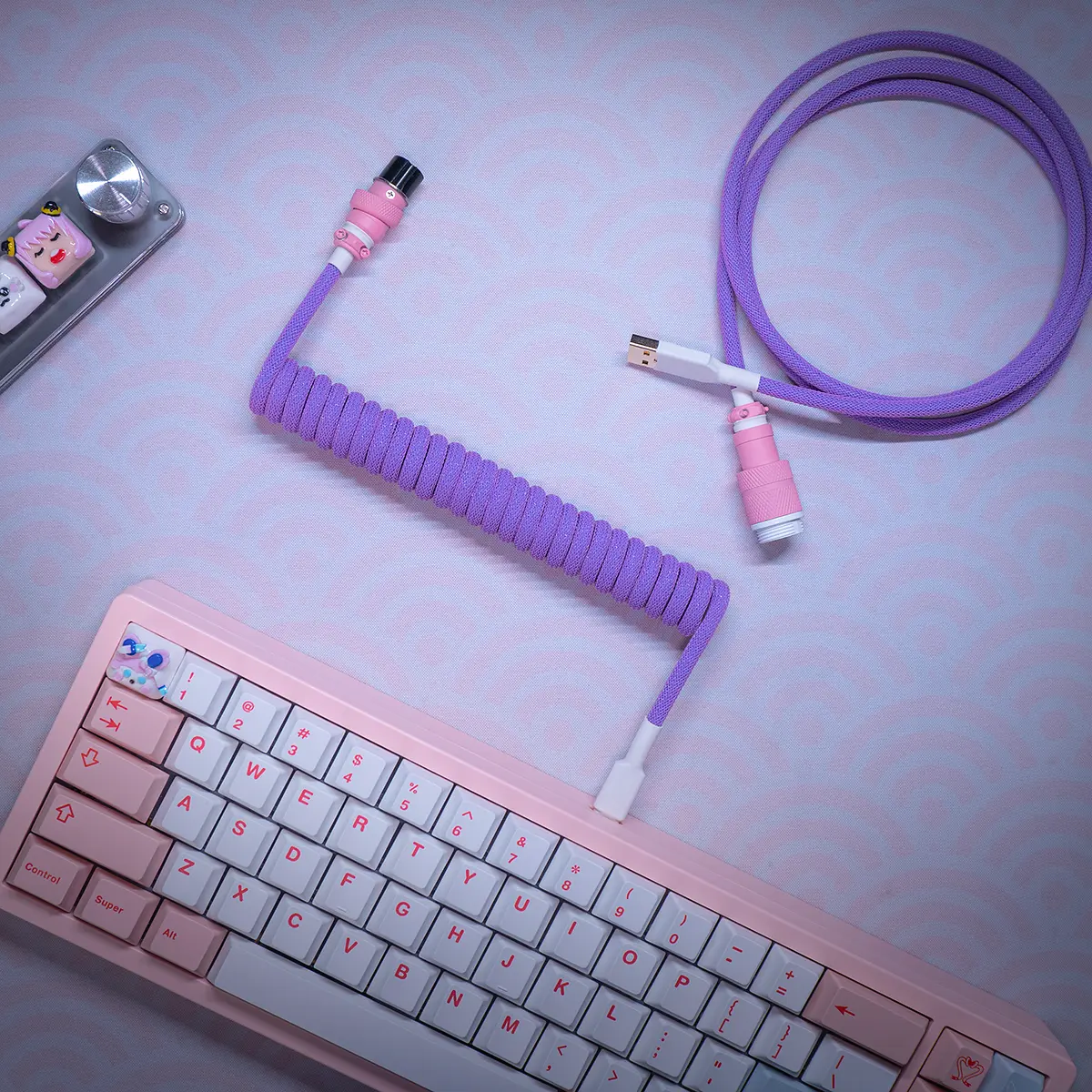 Coiled purple keyboard cable featuring detachable USB-C and GX16 connectors, with a smooth finish and matching pink accents for a stylish look.