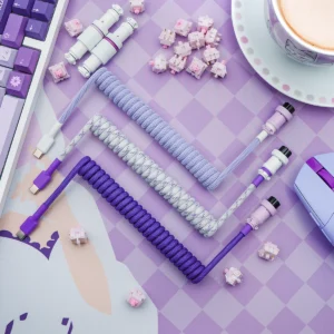 A set of custom keyboard cables featuring coiled designs in purple and lavender, USB-C and aviator connectors, and a sleek, braided finish for durability.