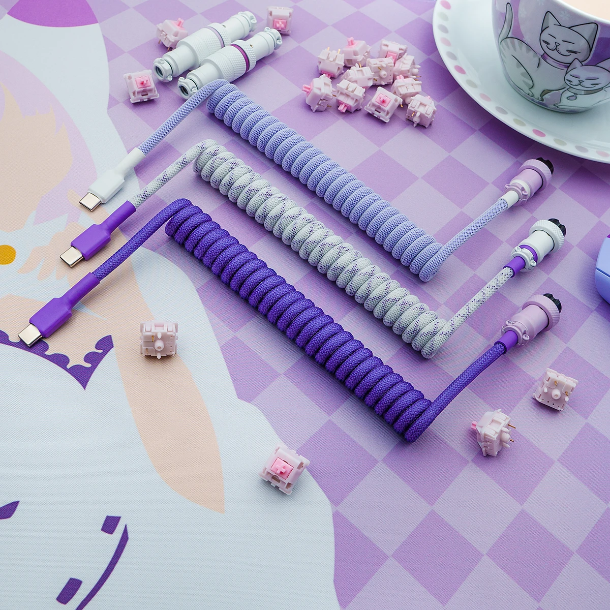 Three custom keyboard cables with vibrant purple and grey paracord braiding, featuring USB-C, detachable aviator connectors, and styled for aesthetics.