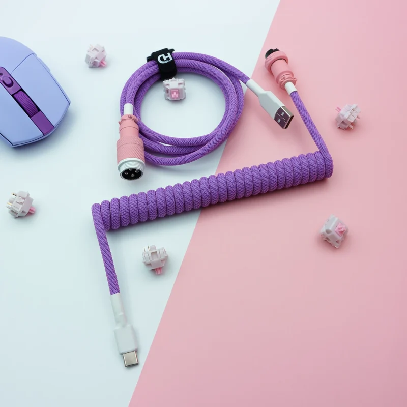Purple coiled keyboard cable featuring a USB-C connector, detachable aviator plug, and high-quality braided paracord design, ideal for custom setups.