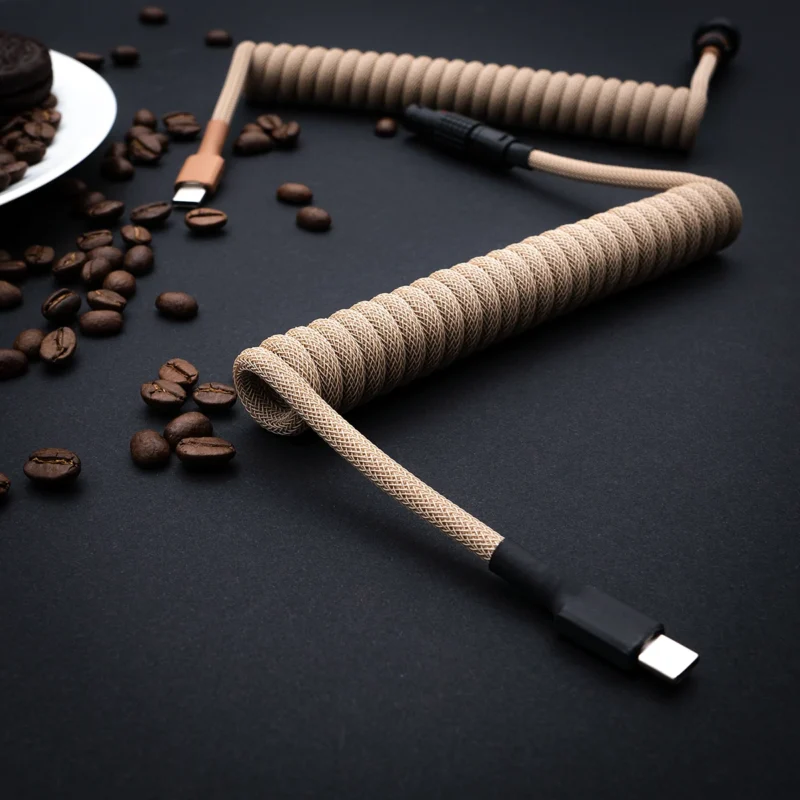 Custom GMK Café keyboard cable featuring a stylish coil design in a neutral color, USB-C connector, and high-quality heatshrink for durability.