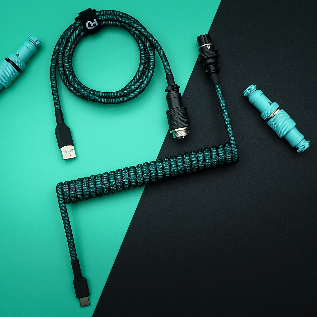 A coiled paracord keyboard cable featuring USB-C and aviator connectors, enhanced with textured finishes and high-quality braiding for durability.