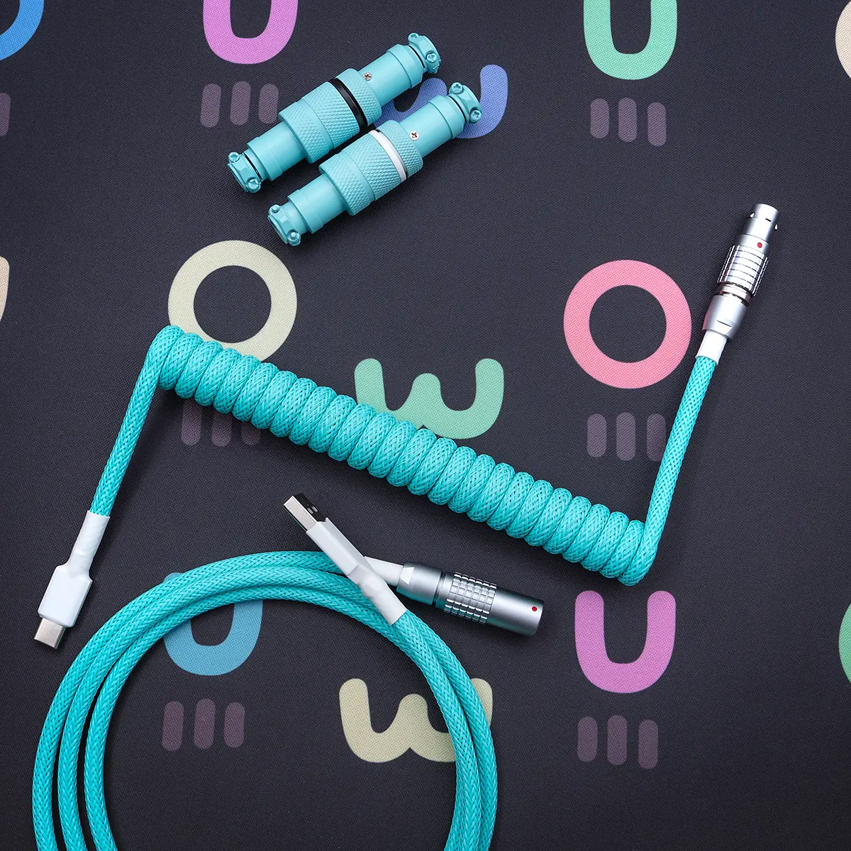 Custom teal keyboard cable featuring a coiled section, a straight USB-C end, and detachable aviator connectors for versatility. High-quality braiding enhances durability.