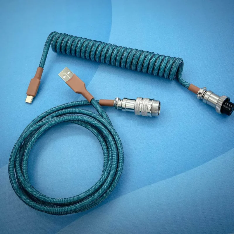 Coiled PBT Islander Nook Keyboard Cable in teal, featuring a USB-C connector, aviator plug, and braided finish for durability and style.
