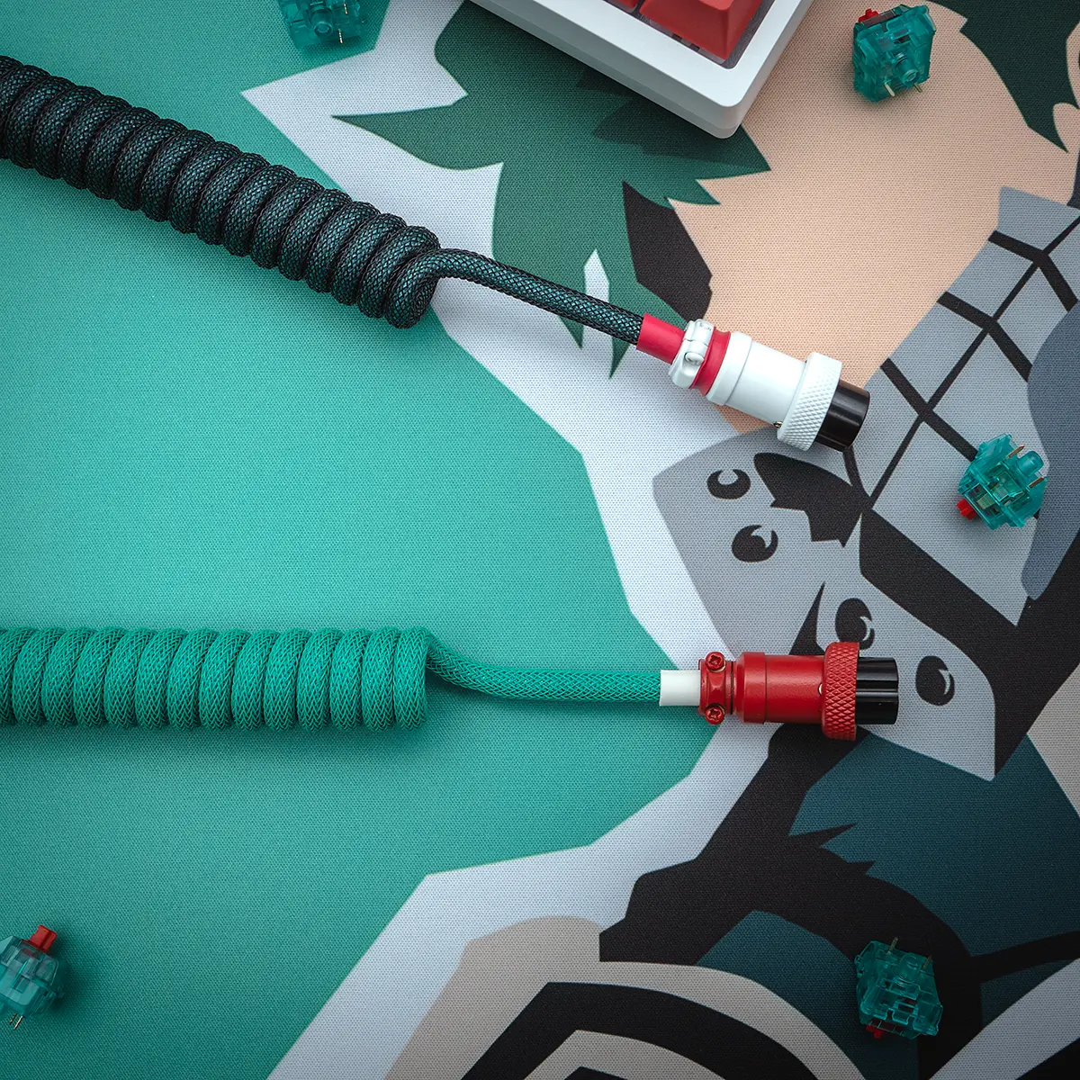 A vibrant GMK Deku keyboard cable featuring a coiled design, detachable connectors, and high-quality braiding in teal and black. Perfect for customization!