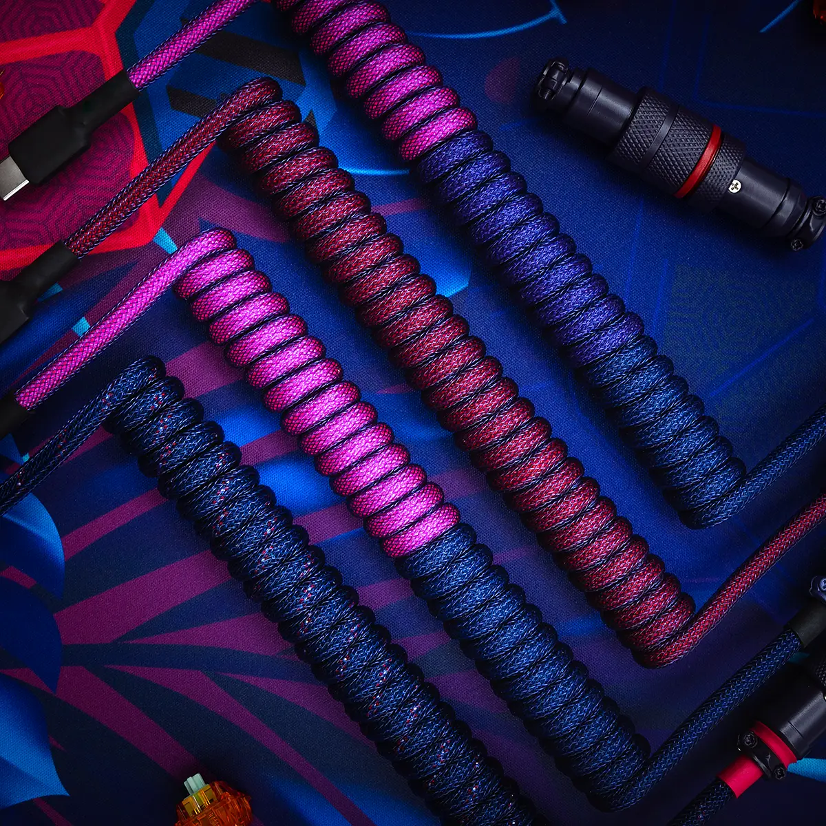 Colorful GMK Laser keyboard cables showcase intricate braiding, featuring a mix of USB-C and aviator connectors. Each coil is designed for durability and style.