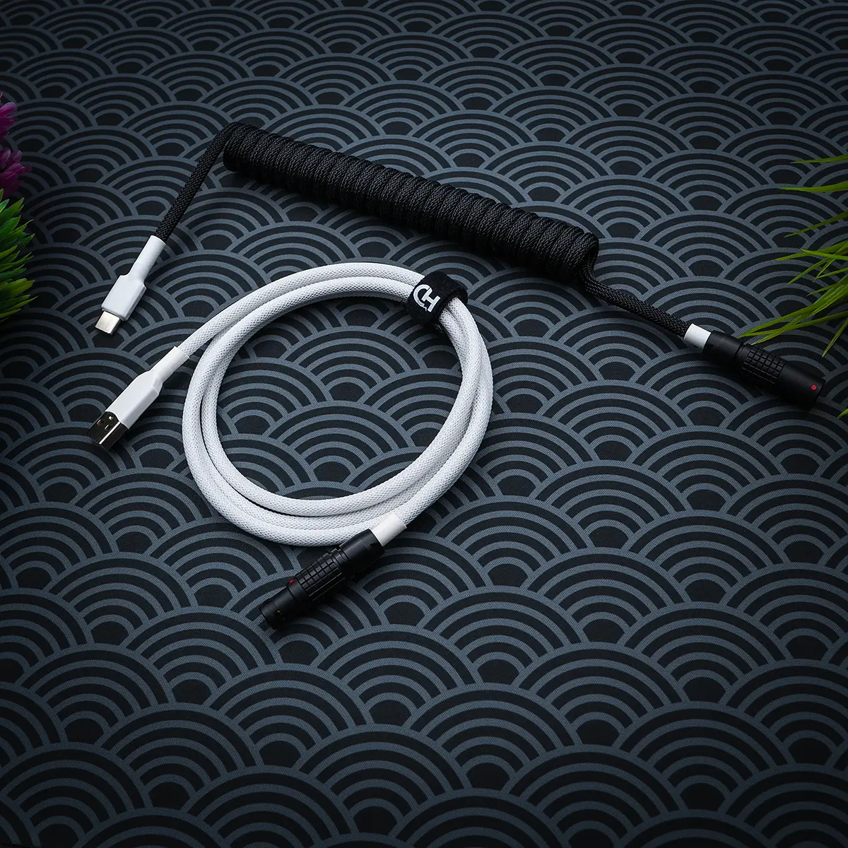 A stylish GMK Wob keyboard cable featuring a white coiled paracord design, USB-C and aviator connectors, and quality heatshrink for durability.
