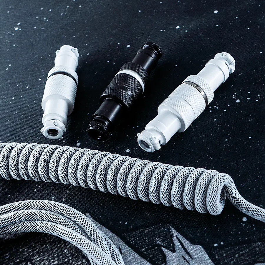 Coiled gray custom keyboard cable featuring detachable USB connectors in black and white. Durable paracord and textured finish enhance quality.
