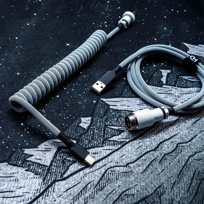 Coiled gray keyboard cable with USB-C and aviator connectors. Features durable techflex braiding, clean heatshrink, and premium metal housing.