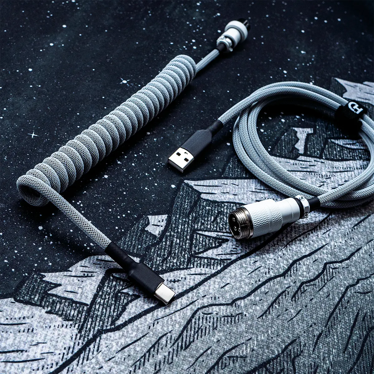Coiled gray keyboard cable with USB-C and aviator connectors. Features durable techflex braiding, clean heatshrink, and premium metal housing.