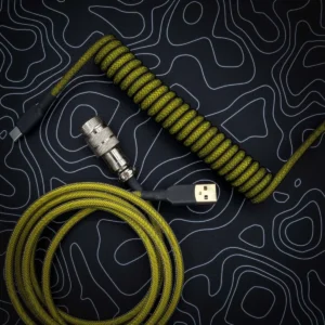 Coiled yellow and black keyboard cable featuring USB-C and aviator connectors, with durable paracord braiding and quality heatshrink for enhanced aesthetics.